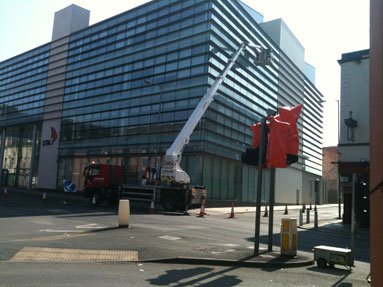 Cleaning the outside of a building using a cherry picker